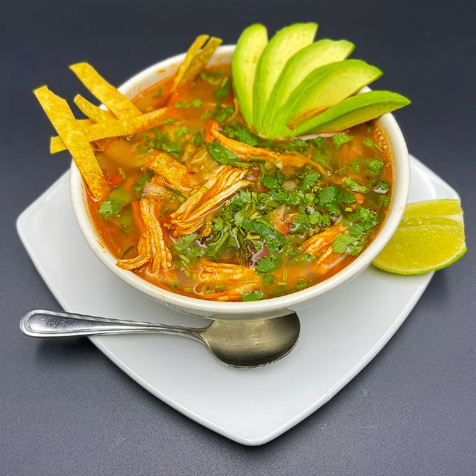 El Don Mexican Restaurant's chicken tortilla soup with avocado, cilantro, tortilla strips, and lime.