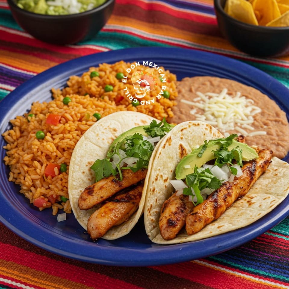 El Don Mexican Restaurant's chicken tacos with rice, refried beans, guacamole, and chips on a colorful tablecloth.